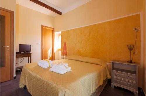 a bedroom with a bed with towels on it at Jolly Roger Affittacamere in La Spezia