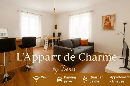 a living room with a couch and a table at appart de charme a 2 pas du centre de Montbrison in Montbrison