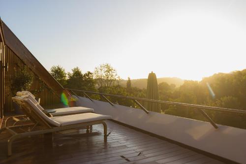 a couple of lounge chairs sitting on a balcony at Wellnesshotel Thermae 2000 in Valkenburg