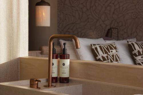 two bottles of wine on a counter next to a bed at Wellnesshotel Thermae 2000 in Valkenburg