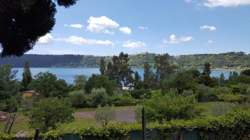 a view of a lake from a garden at Il Nido del Falco in Castel Gandolfo