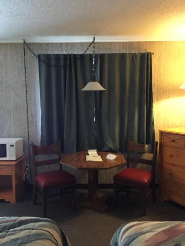 a room with a table and two chairs and a window at Z Bar Motel in Buffalo