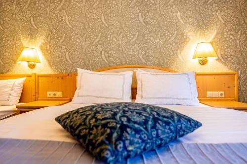 a bed with a large pillow on top of it at Landidyll Hinterhermsdorf by STEIGER Hotels in Hinterhermsdorf