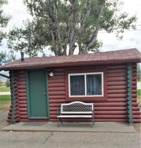 a small cabin with a bench in front of it at Z Bar Motel in Buffalo