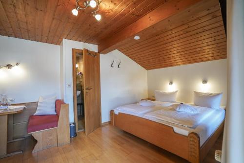 a bedroom with a bed and a wooden ceiling at Beim Nuihausa in Reit im Winkl