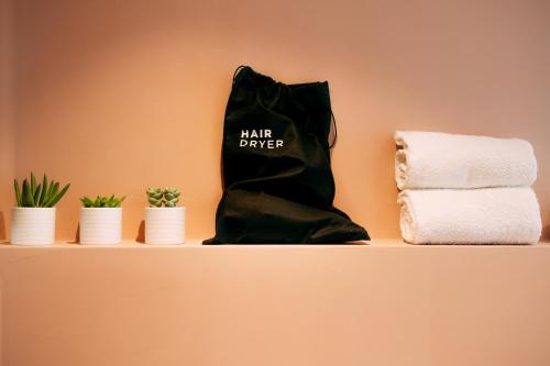 a black boot sitting on a shelf next to towels at Borgo di Lazise in Lazise
