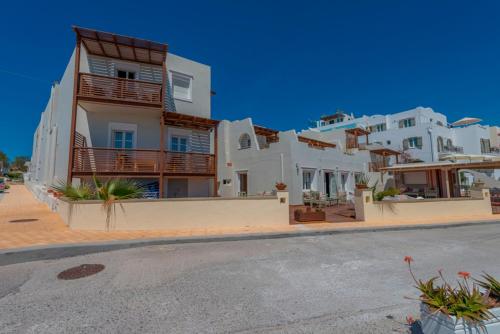 a row of white houses on the side of a street at Nissaki Beach Hotel in Naxos Chora