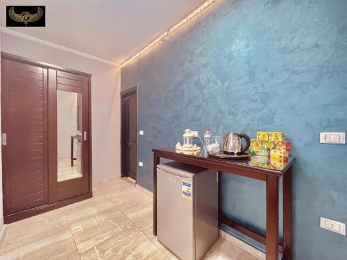 a room with a counter and a blue wall at Comfort Inn Pyramids Hotel in Cairo