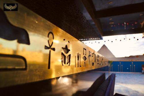 a wall in a room with writing on it at Comfort Inn Pyramids Hotel in Cairo