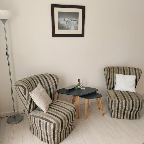 a living room with two chairs and a table at Landhaus Brüne in Bad Wildungen