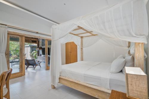 a bedroom with a bed with a canopy at Bali Bagus Villa in Amed