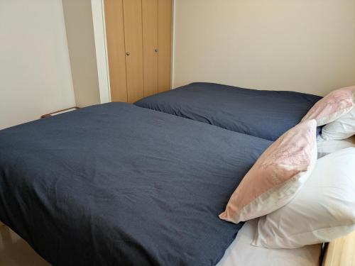 Ένα ή περισσότερα κρεβάτια σε δωμάτιο στο Hana Hostel Fujisan Apartment