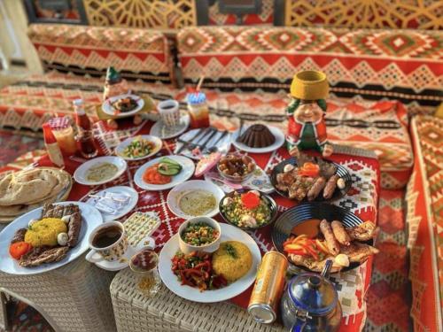 a table filled with plates of food on a table at Comfort Inn Pyramids Hotel in Cairo