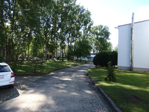 a road with a car parked on the side at Zur Saale in Weißenfels