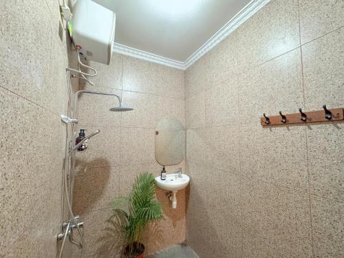 a bathroom with a sink and a shower at Rumah Tetangga Jogja - 4BR Villa Near Keraton in Ngabean