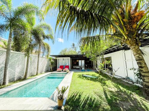 a swimming pool in a backyard with palm trees at Tropical 2BR Escape & Walk to Selong Belanak Beach in Selong Belanak