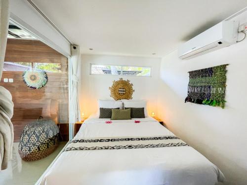 a bedroom with a large bed in a room at Tropical 2BR Escape & Walk to Selong Belanak Beach in Selong Belanak