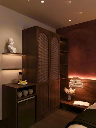 a bedroom with a bed and a wooden cabinet at Nana House Huong River Retreat in Thôn Trường Giang