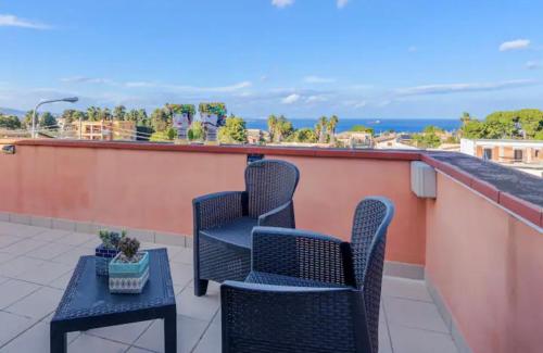 a patio with two chairs and a table on a roof at A Ficu Pala in Siracusa