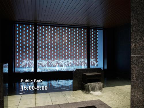 a building with a large window with a picture of a bridge at Mitsui Garden Hotel Sapporo West in Sapporo