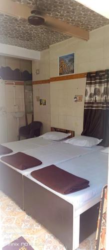 a room with two beds in a room at Dwarkesh homstey in Dwarka