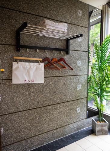 a wall in a room with a shelf with food at Jungle City Motel in Chiayi City