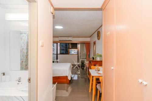 a room with a bed and a table and a bathroom at srivaramansion 1 by cream in Ban Na Song