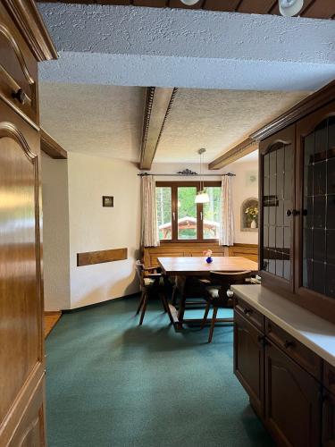 a dining room with a table and a window at Ferienhaus Wimmer in Faistenau