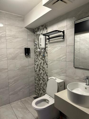 a bathroom with a toilet and a sink at Arte Cheras in Kuala Lumpur