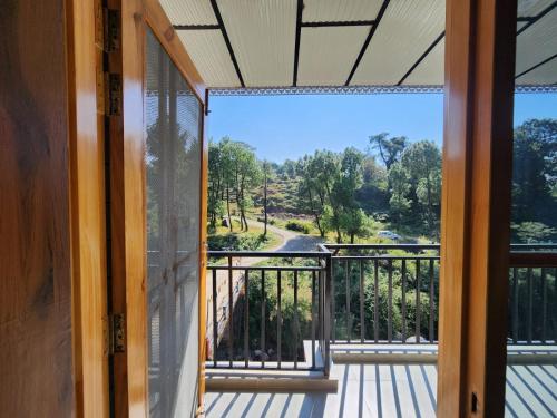 a view from the balcony of a house at riverview villa in Bīr