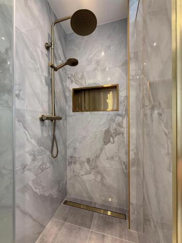 a bathroom with a shower with a glass door at City Apartment Varel in Varel