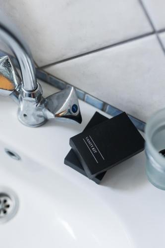 a book sitting on a sink next to a faucet at Casa Natura in Kilkis