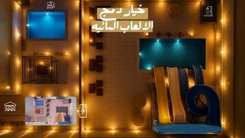 a room with a wall with lights and a book shelf at Tamyoz Aqama for Serviced Apartments in Hail
