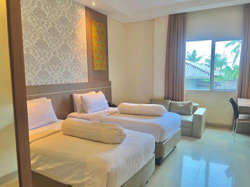 Ένα ή περισσότερα κρεβάτια σε δωμάτιο στο Nevada Ketapang Hotel