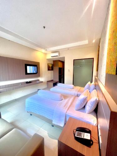 Ένα ή περισσότερα κρεβάτια σε δωμάτιο στο Nevada Ketapang Hotel
