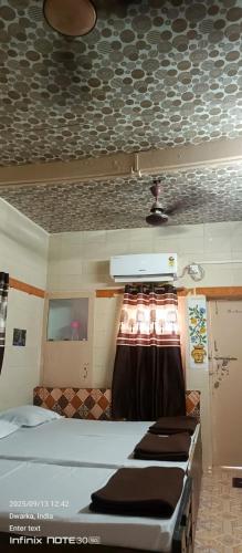 a room with a group of beds in a room at Dwarkesh homstey in Dwarka