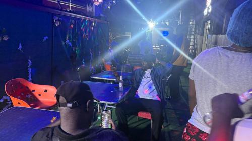a group of people sitting in a room with lights at da vics hotel rooms airport pickup available in Lagos