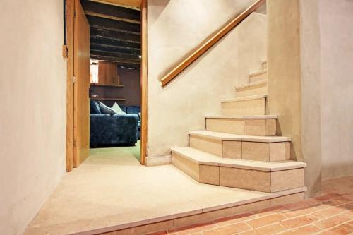 a staircase in a living room with a couch at Prince Albert's Place in Hebden Bridge