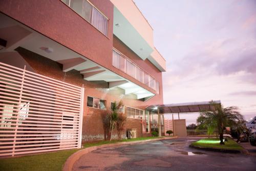 a red brick building with a gate in front of it at Italian Palace Hotel in Palmas