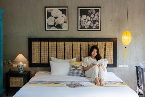Postel nebo postele na pokoji v ubytování Nghé Garden Resort Hội An