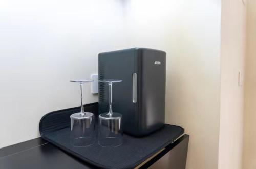 a black appliance on a black table with two glasses at A casa di Clà in Gaeta