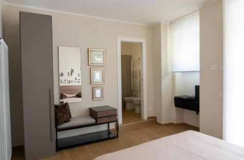 a bedroom with a bed and a mirror and a bathroom at A casa di Clà in Gaeta