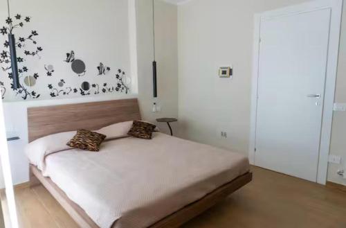a bedroom with a bed in a white room at A casa di Clà in Gaeta