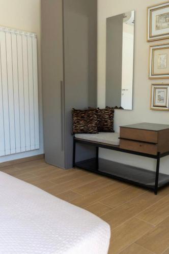 a bedroom with a bed and a dresser and a mirror at A casa di Clà in Gaeta