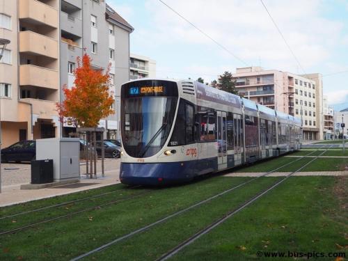 a bus is on the tracks in a city at La Suite - tram access and private parking in Annemasse