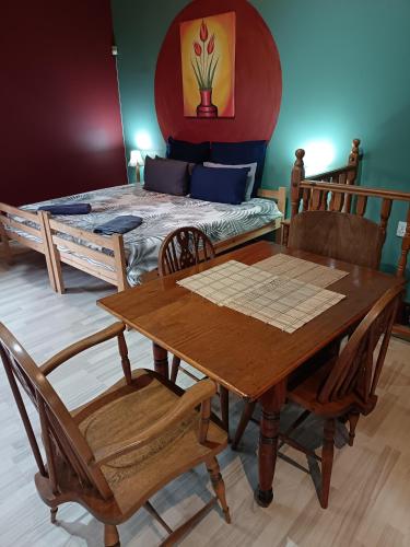 a dining room with a table and chairs and a bed at Apartment-double storey-2 bedrooms-own bathroom, kitchen, dining room, entrance, lounge, patio in Pinetown