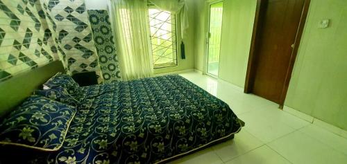 a bedroom with a bed and a window at Penthouse in Rawalpindi
