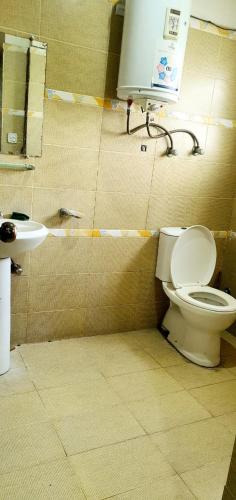 a bathroom with a toilet and a sink at Penthouse in Rawalpindi