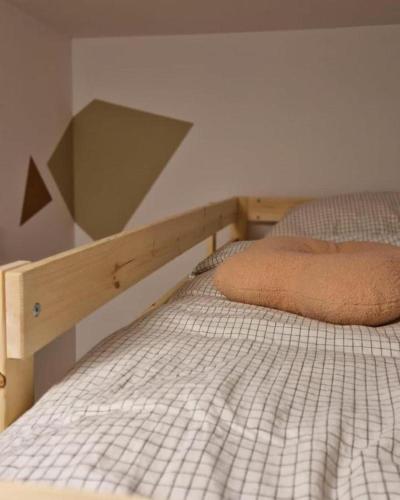 a bedroom with a bed with a wooden headboard at La Rocha in La Roche-en-Ardenne