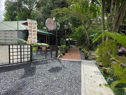 a walkway leading to a restaurant with a gate at Paradise Langkawi in Pulau Tepur